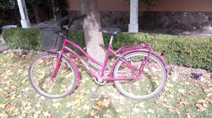 Bicicleta rosa con canasto