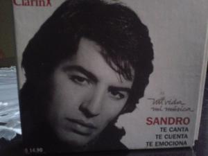 caja con un cd y el album de la vida de sandro